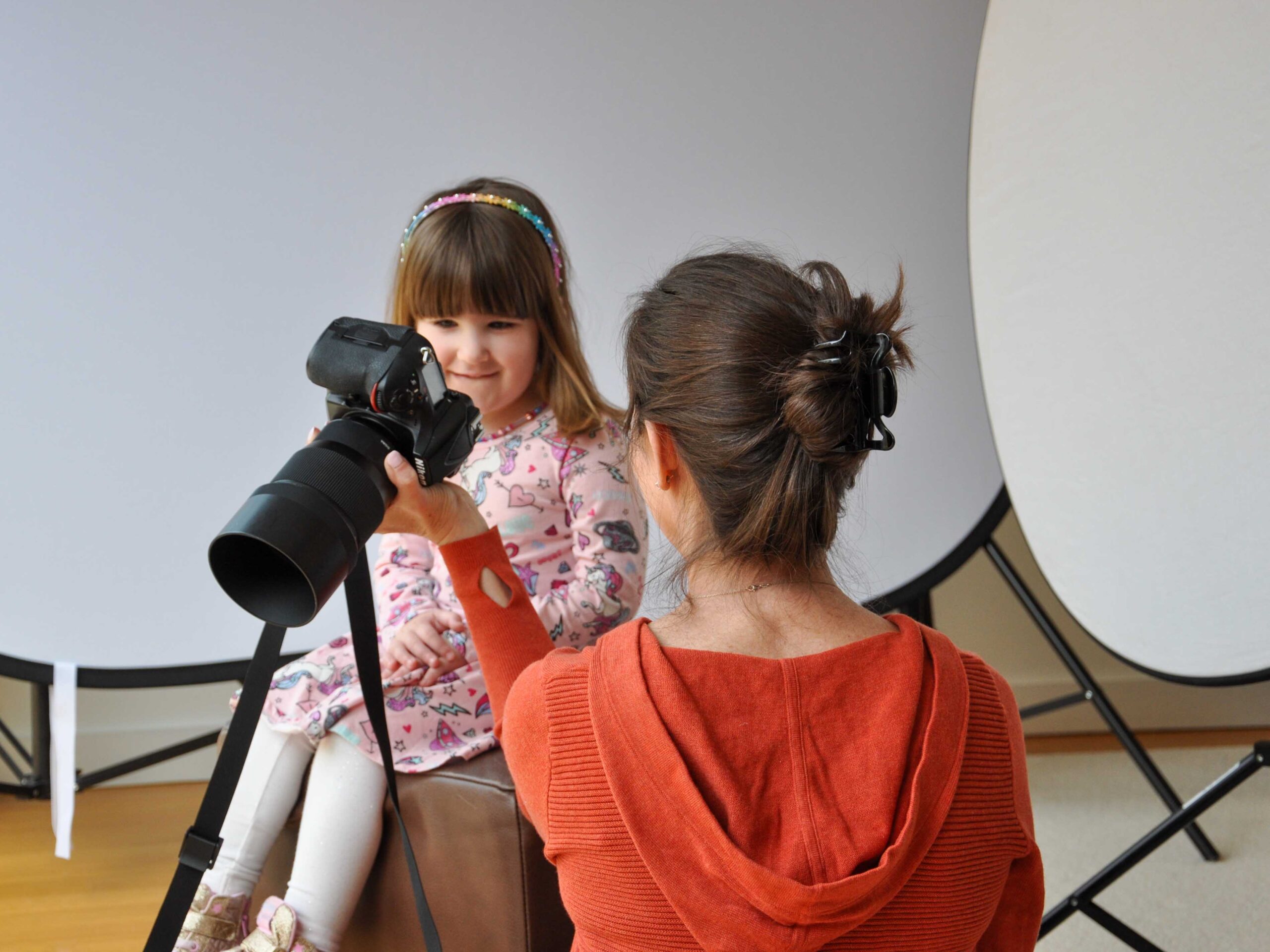 Gigi Photographing-1 Shine A Light Photographer, Gigi DeManio, shows a little girl her photograph on a camera