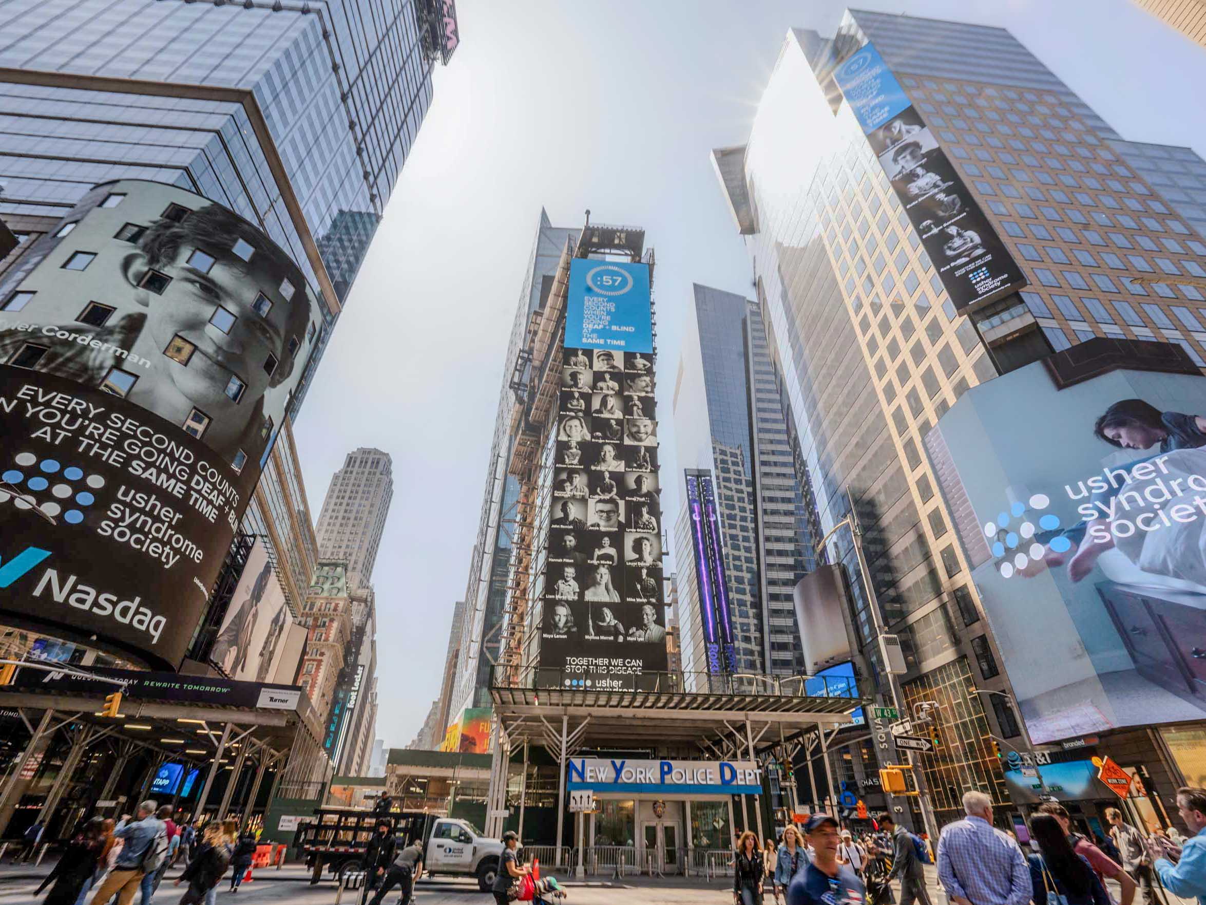 Shine A Light in Times Square Billboards in Times Square NYC featuring portraits of people with Usher syndrome from the Usher Syndrome Society's Shine a Light