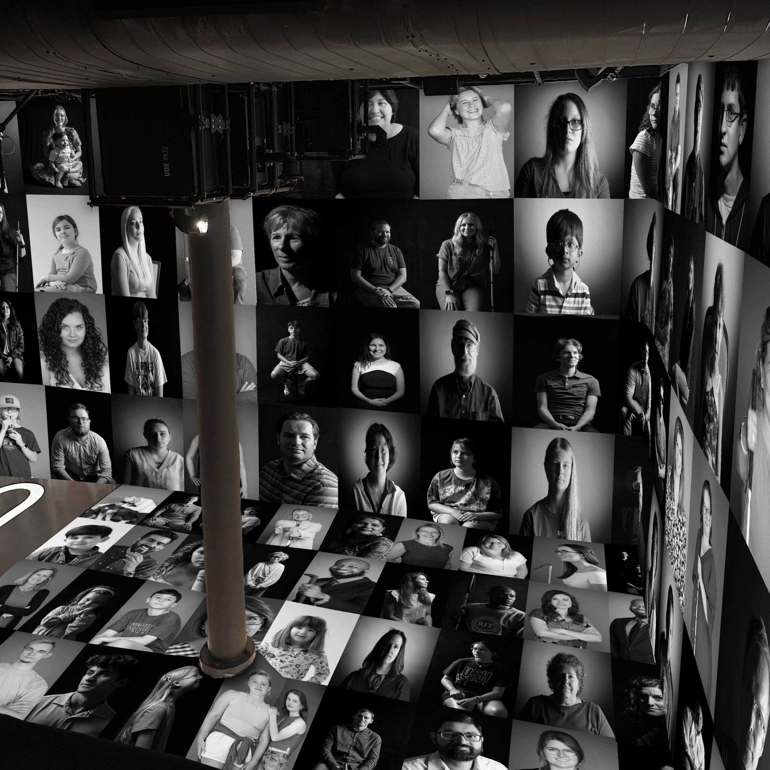 Wall and Floor Portrait mockup A mockup of the Artechouse NYC space featuring black and white portraits from the Shine a Light on Usher Syndrome exhibit on the walls and floor