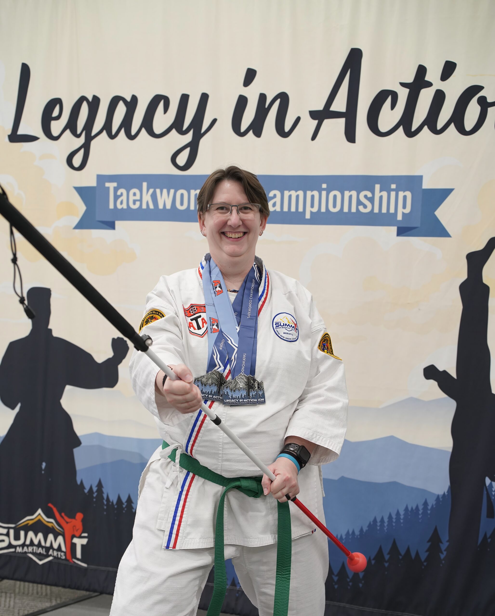 Laurie McBride Legacy in Action Tournament Laurie from the Legacy in Action Tournament wearing her first-place medals for forms, weapons, and sparring.