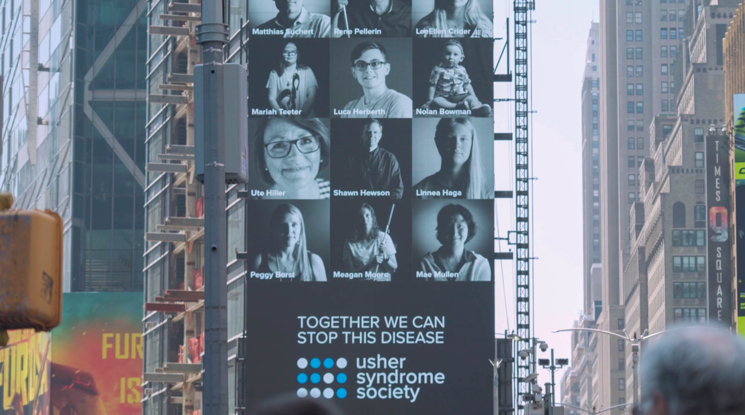 Screenshot One of the billboards in Times Square showing portraits taken by the Usher Syndrome Society.