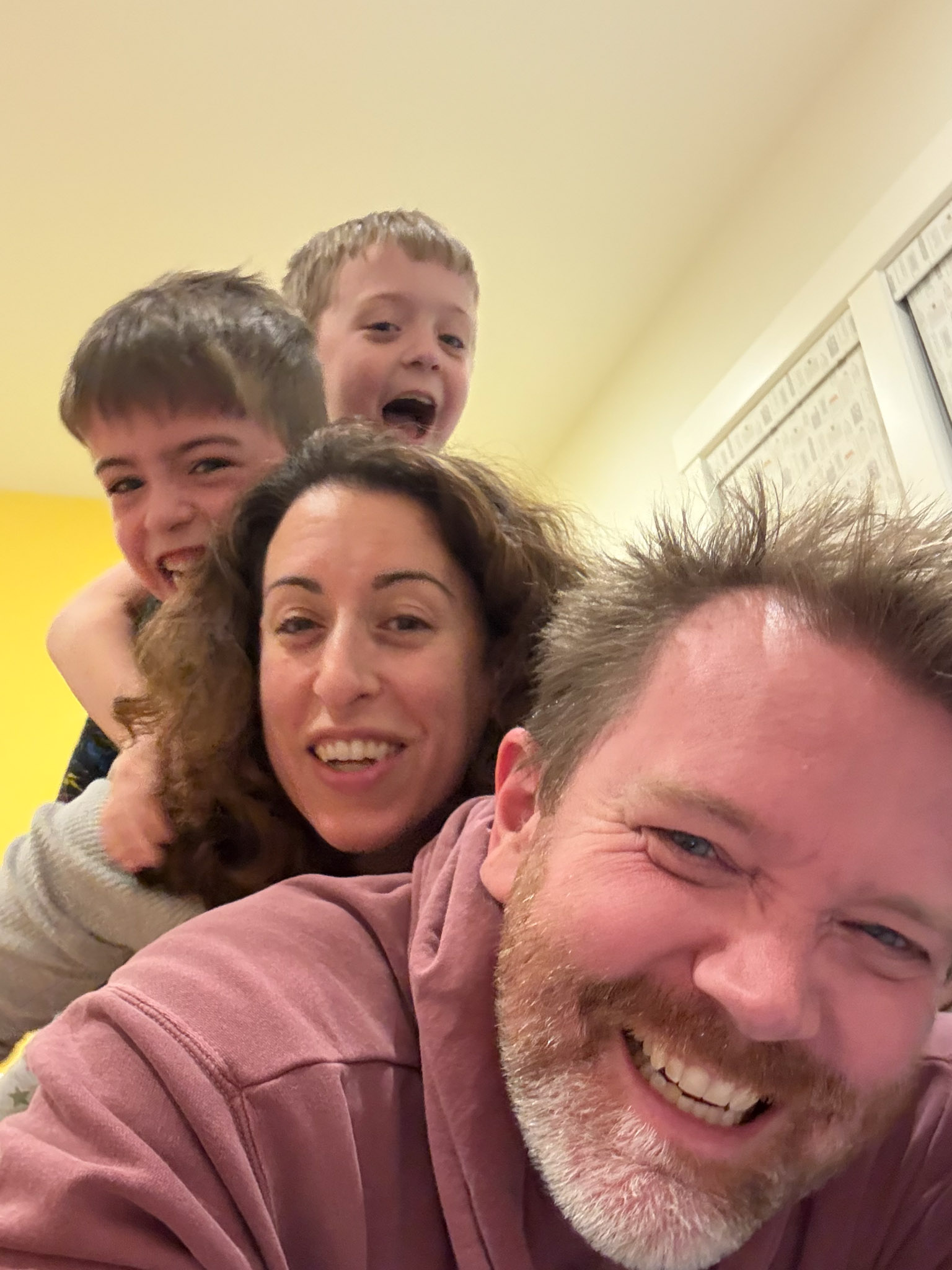 Michael Conn Selfie with Family A selfie photo featuring Michael, his wife, and his two boys all cuddling together and smiling