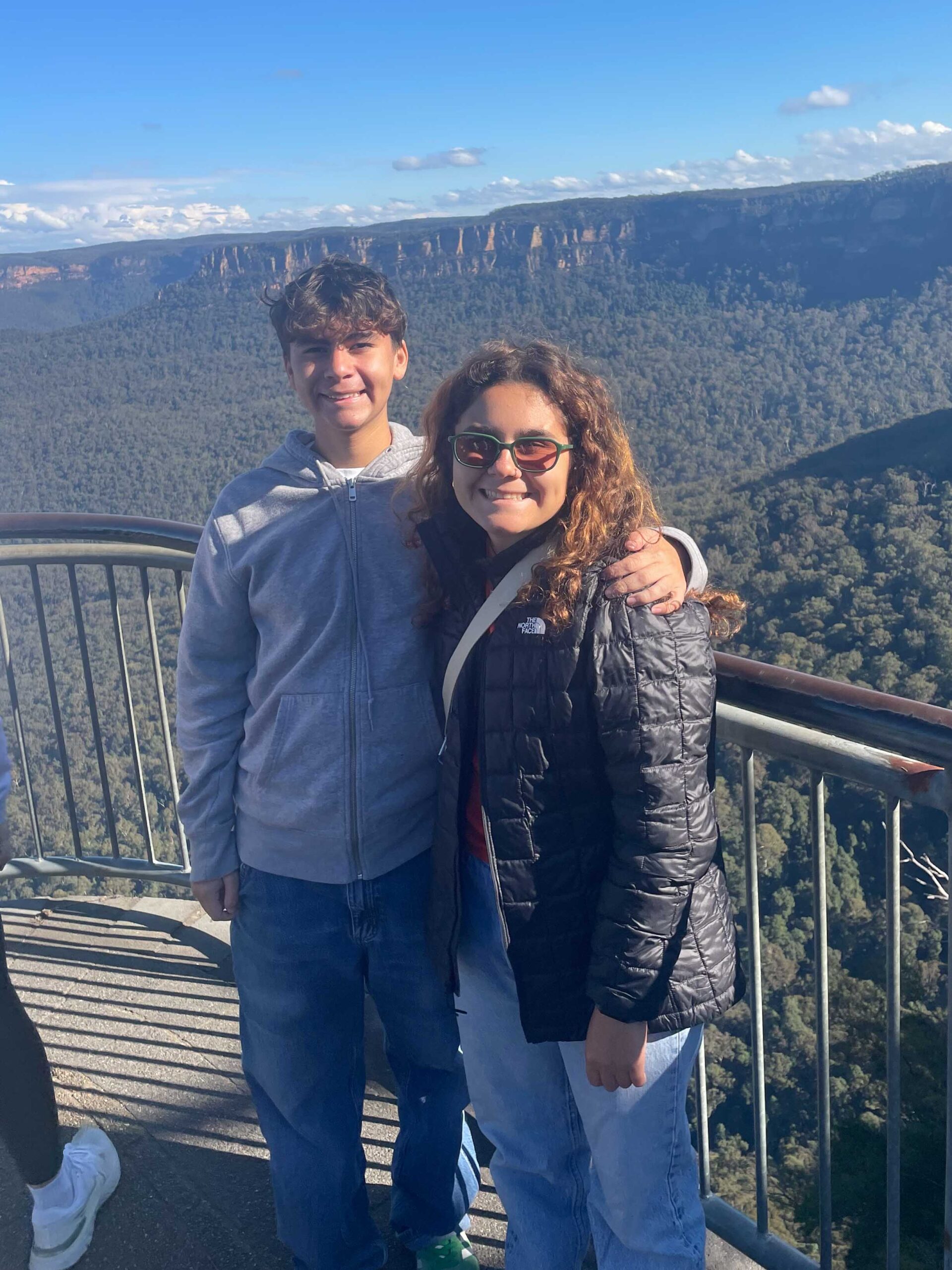  Olivia and her brother, Americo, posing in front of a beautiful view in the Blue Mountains of Australia.
