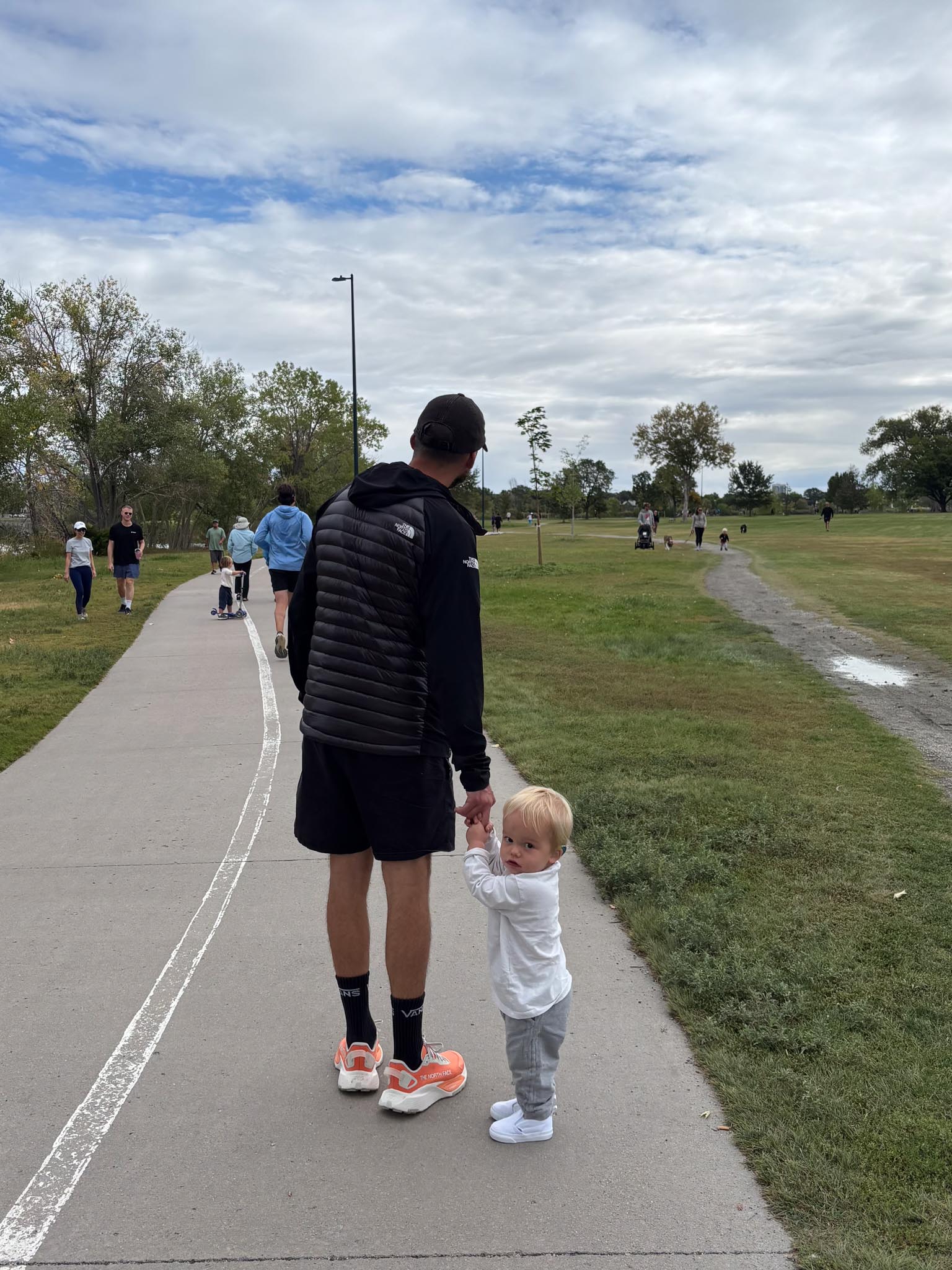 Joey sits on a grey couch with a big smile on his face