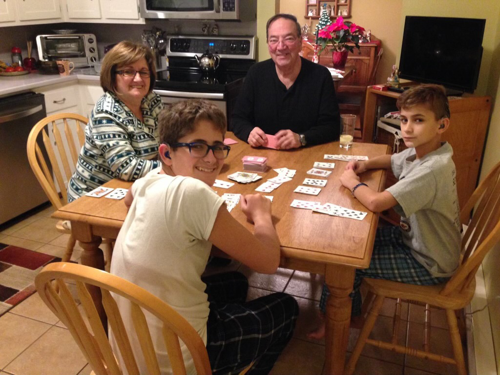 Fran and John playing cards with grandsons Ethan (left) and Gavin in 2015 at their home in Quispamsis, New Brunswick, Canada.