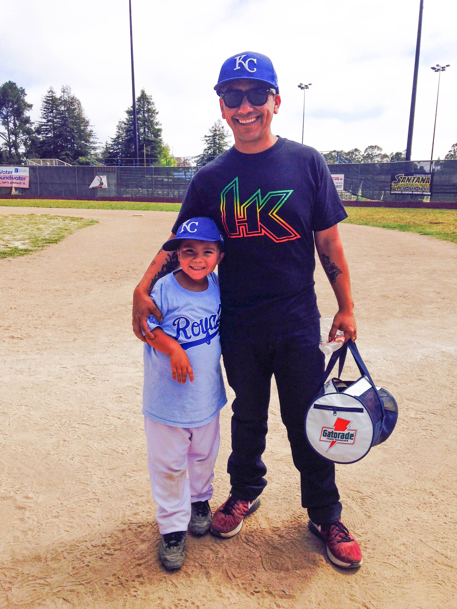 Americo Jr, when he was 6 years old, is at a Little League game with his dad, Americo Sr, at a little league game 