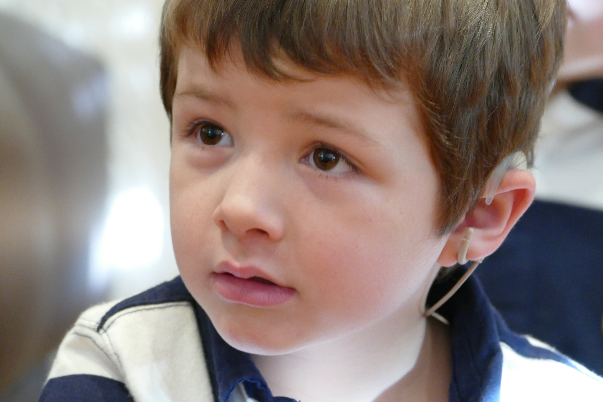 A close up photo of Daniel looking slightly off to the side. He has short brown hair.