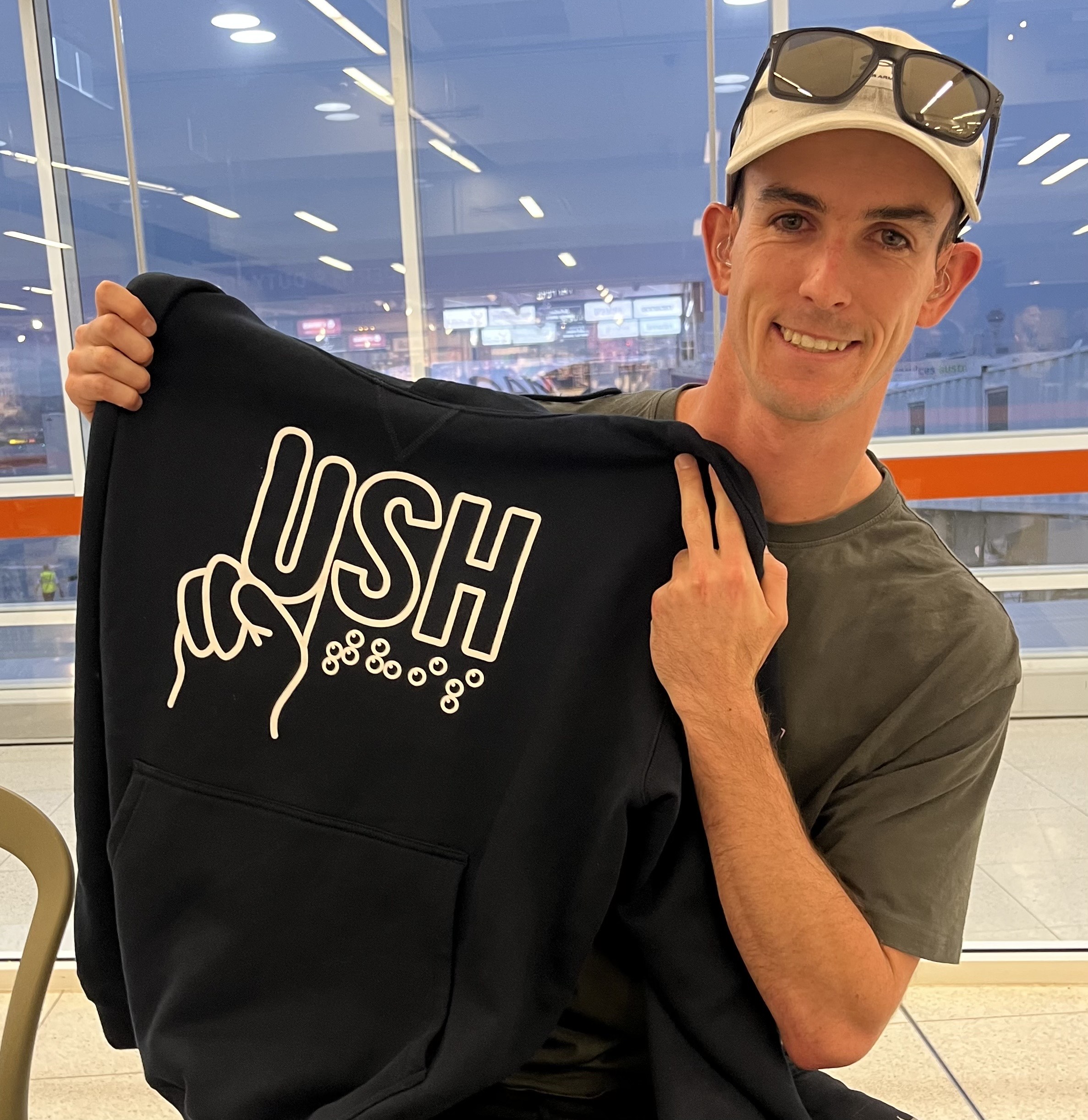 Matt holding up the Australia Camp jumper (hoodie) 