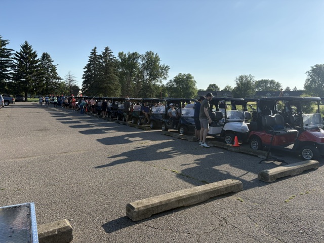 Golf carts lined up on the pavement at the 2026 Grand Rapids Open - Golf for a Cure