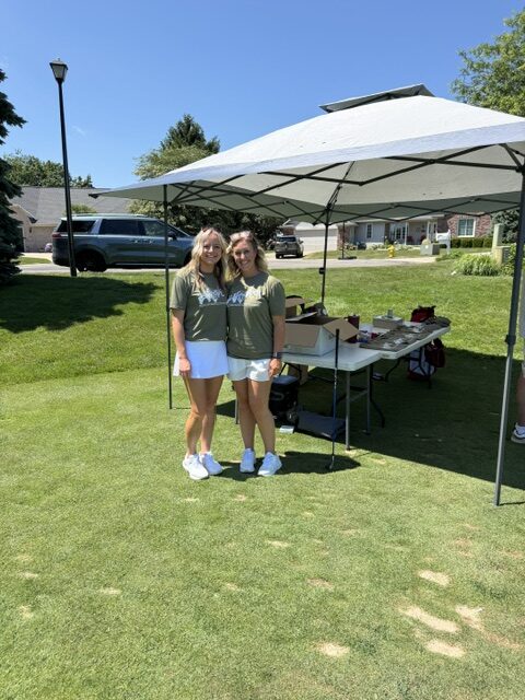Nicole and another woman stand on the golf course at the 2026 Grand Rapids Open - Golf for a Cure
