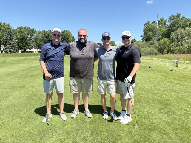 A 4 person team photo at the 2026 Grand Rapids Open - Golf for a Cure
