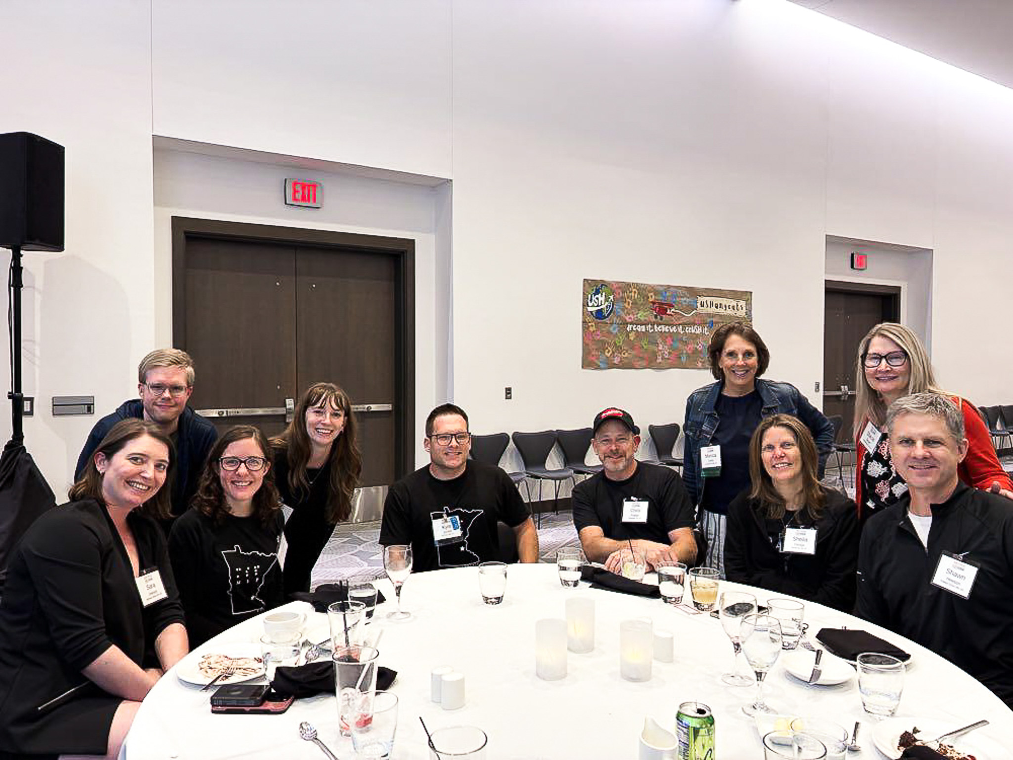 A group of people sit around a table at the USH 2026 Connections Conference